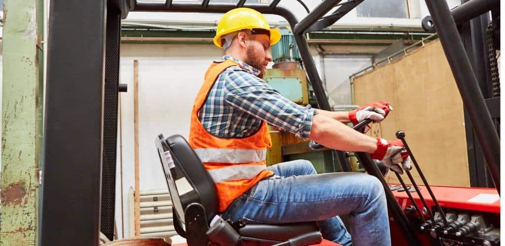 Worker operating forklift